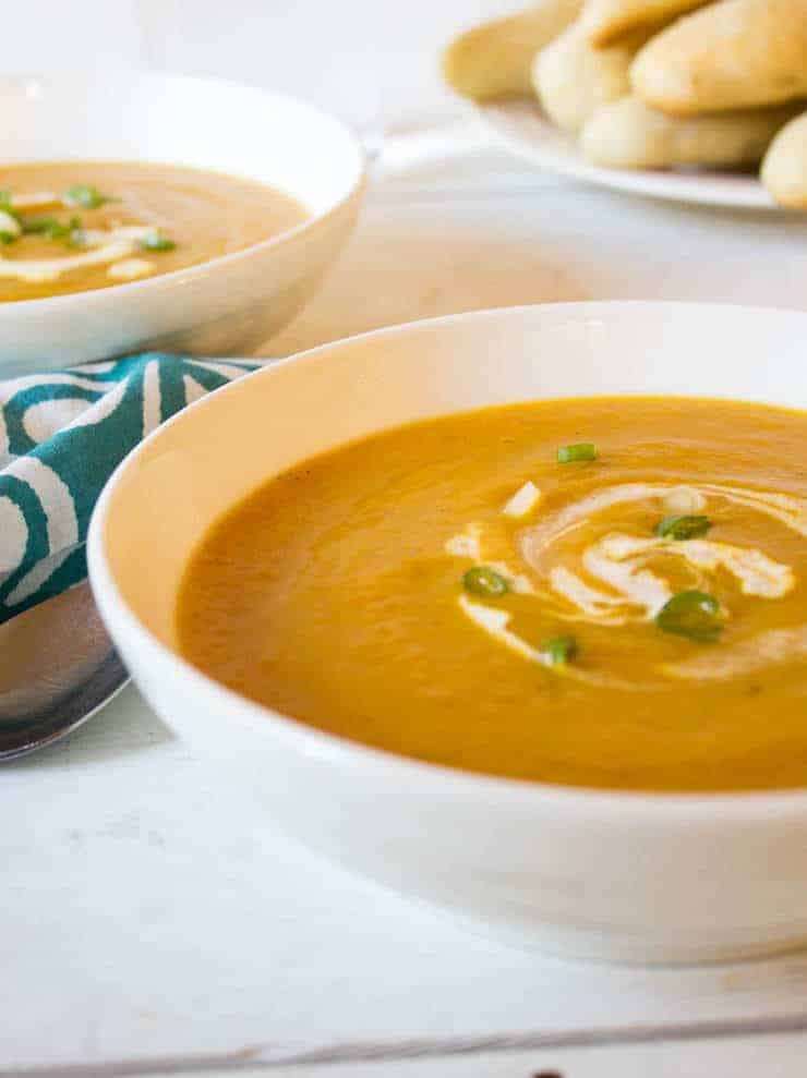 Butternut squash soup with a swirl of cream and green onions.