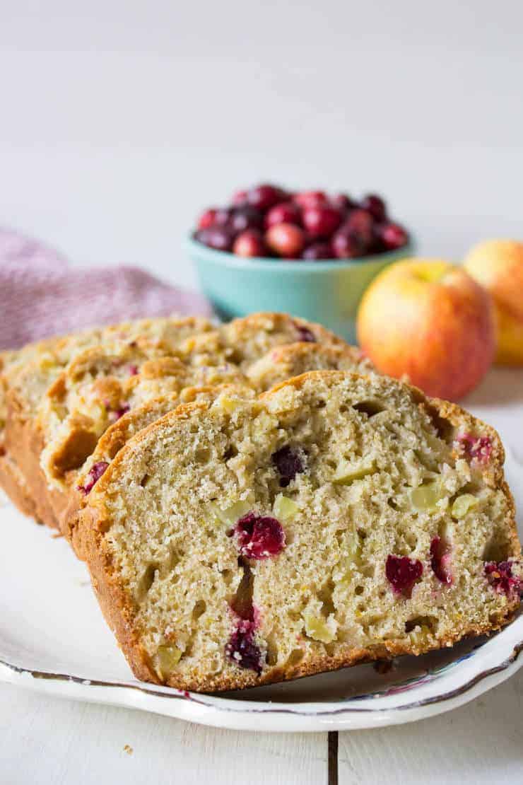 Sliced bread filled with chunks of apples and cranberries.