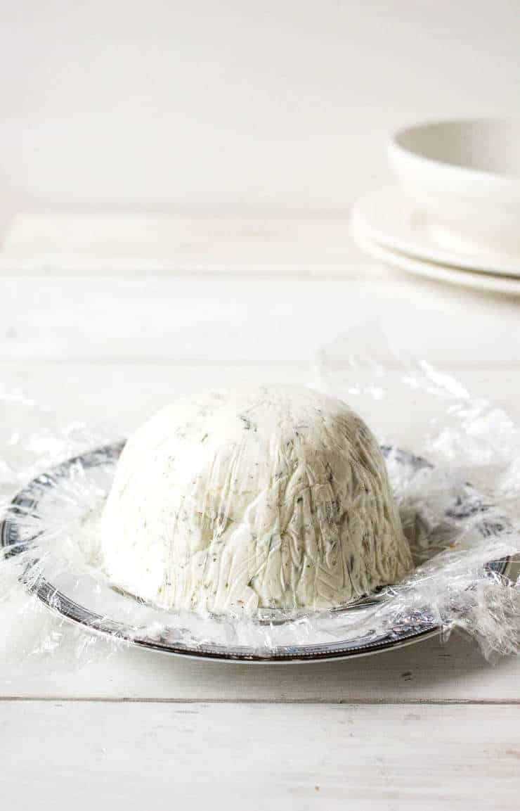 A small cheese ball on a small plate.