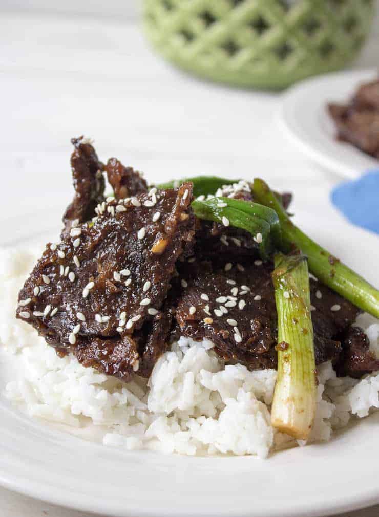 Mongolian Beef topped with sesame seeds and green onions.