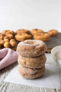 Three donuts stacked on top of each other on a white piece of paper.