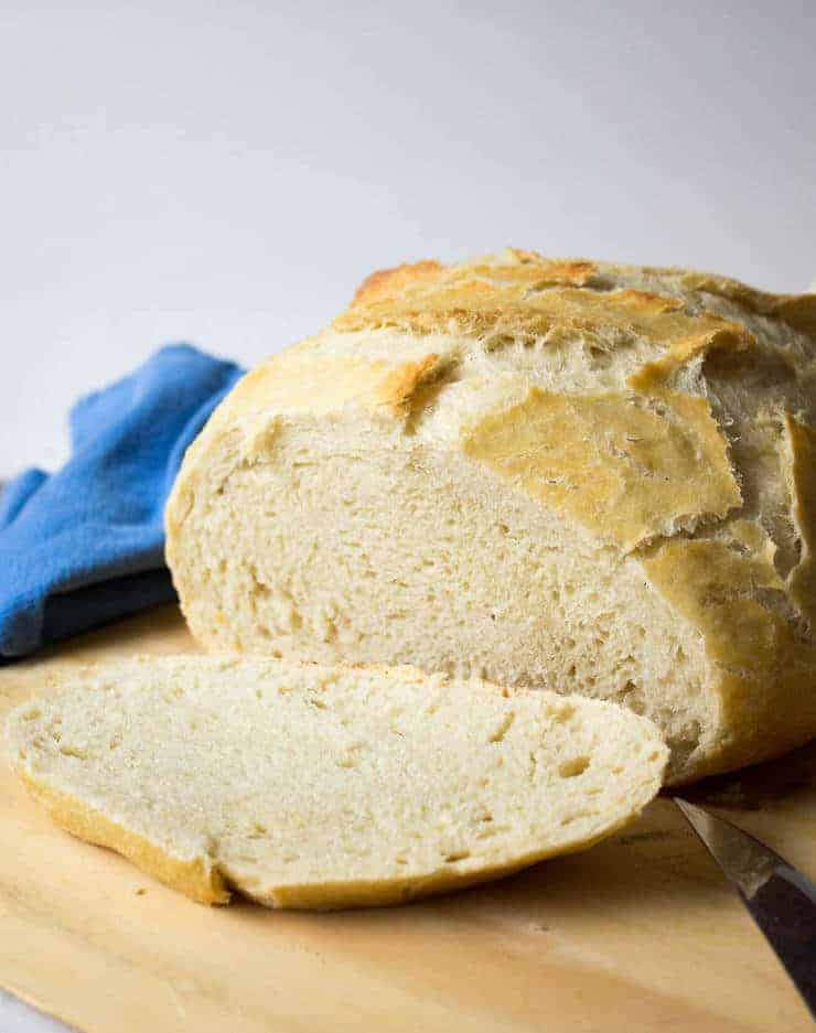 A round loaf of bread with a slice cut off one end.