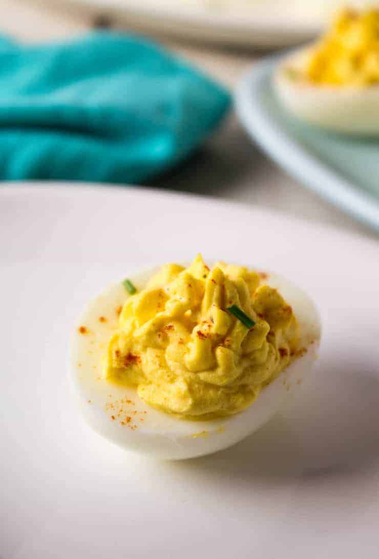 A single egg with yellow filling on a plate. 