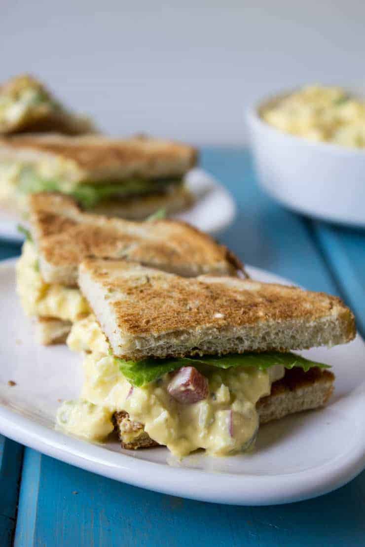 Small toasted sandwiches on a plate.