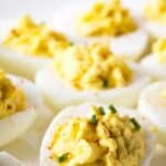 A white platter filled with deviled eggs.