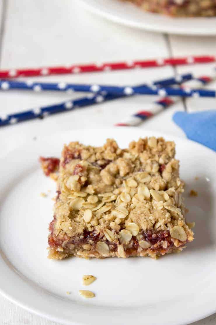 A snack bar topped with oatmeal on a white plate.