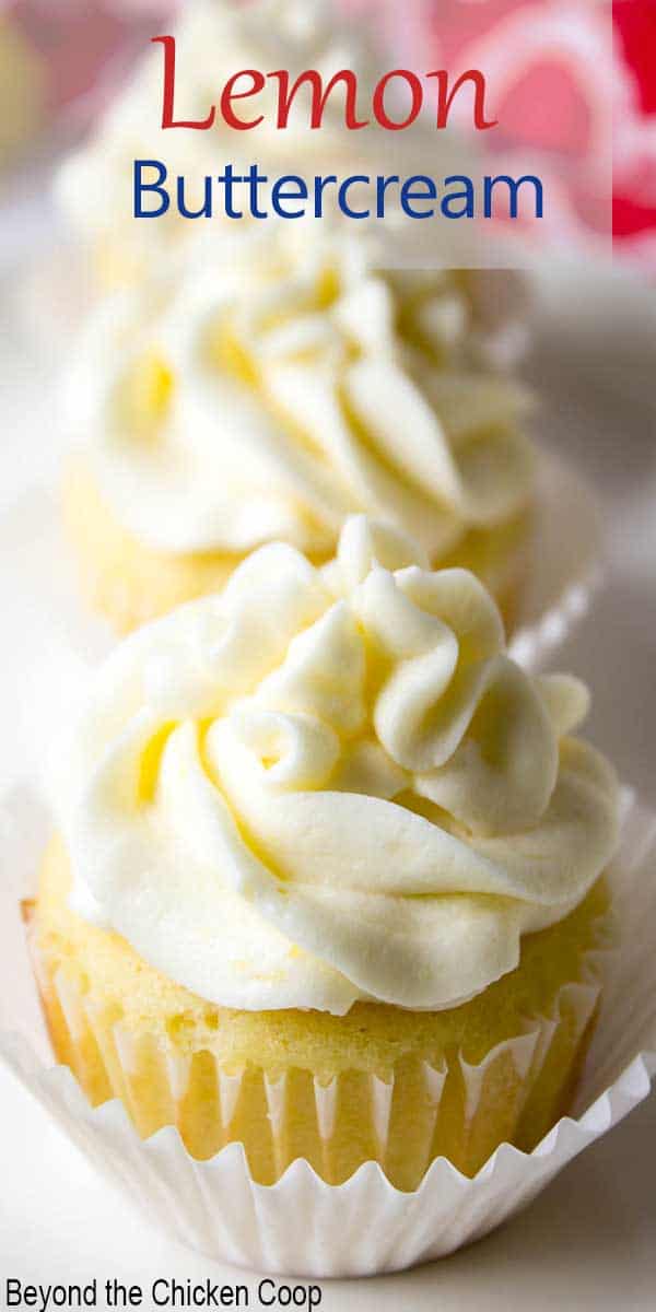A row of cupcakes topped with lemon swirled frosting.