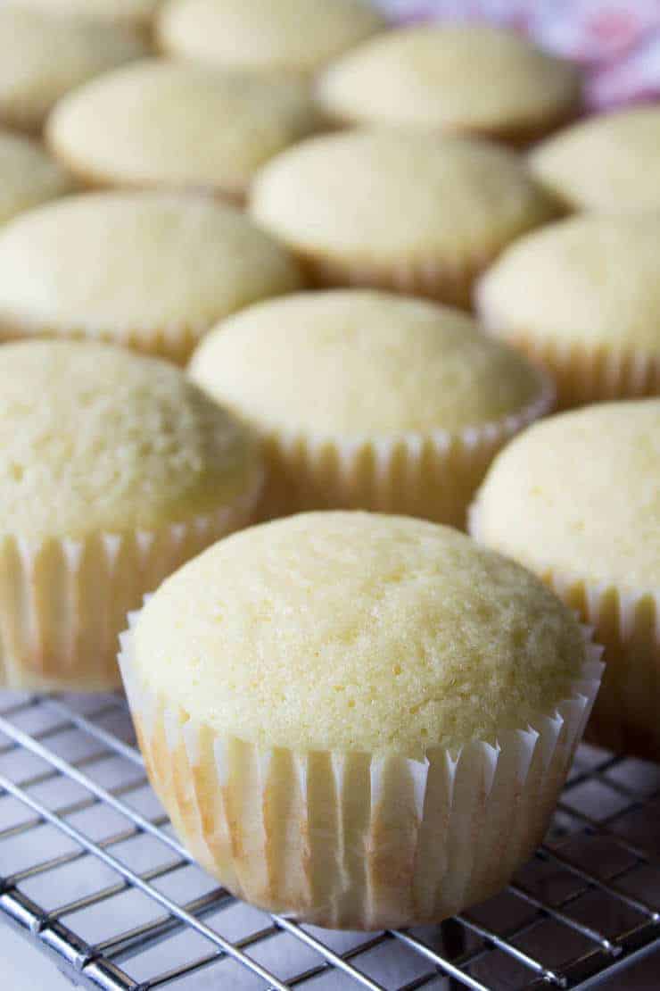 Lemon Cupcakes cooling on a baking rack.