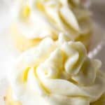 A row of lemon cupcakes topped with a swirled frosting.
