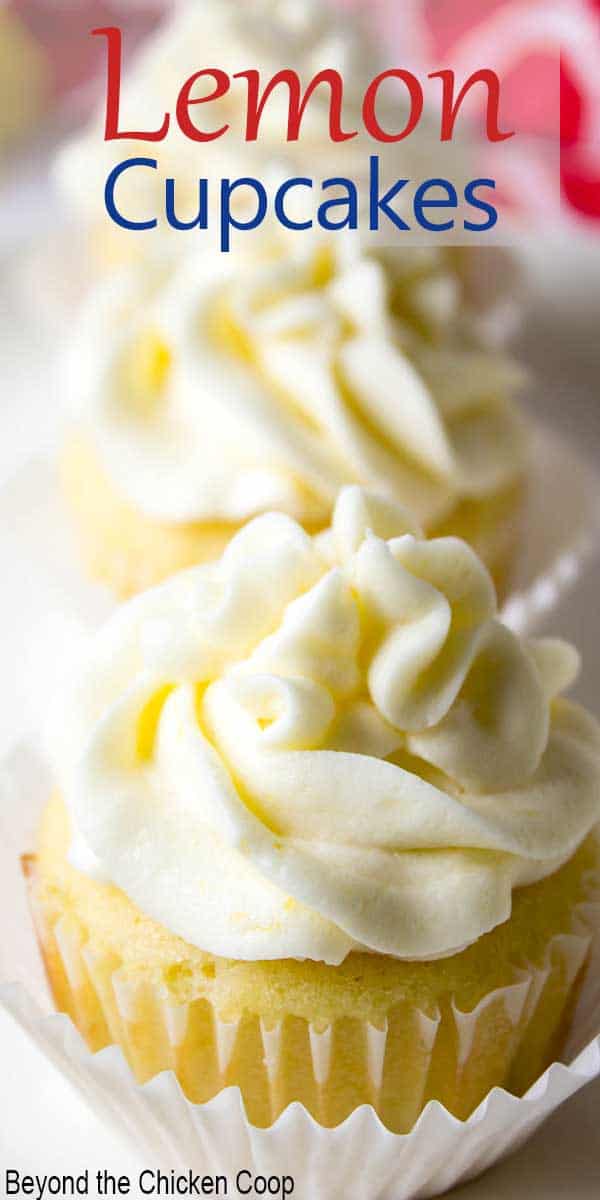 A row of lemon cupcakes topped with a swirled frosting. 