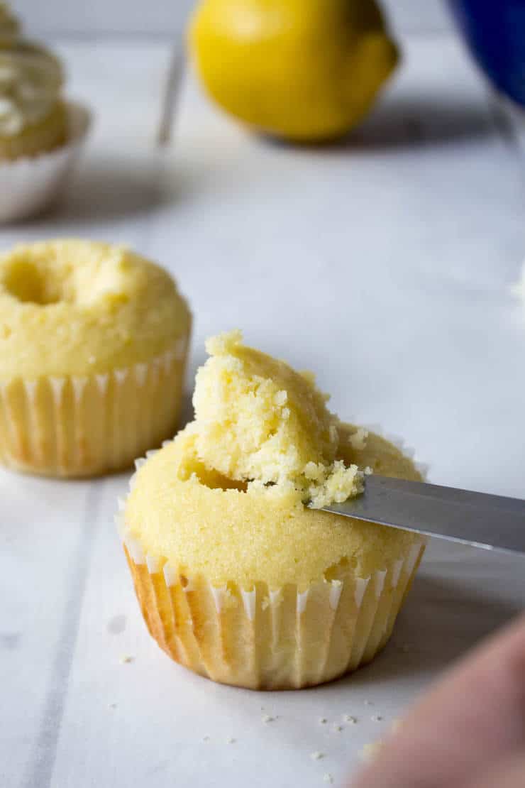 Cutting out the center of a cupcake.