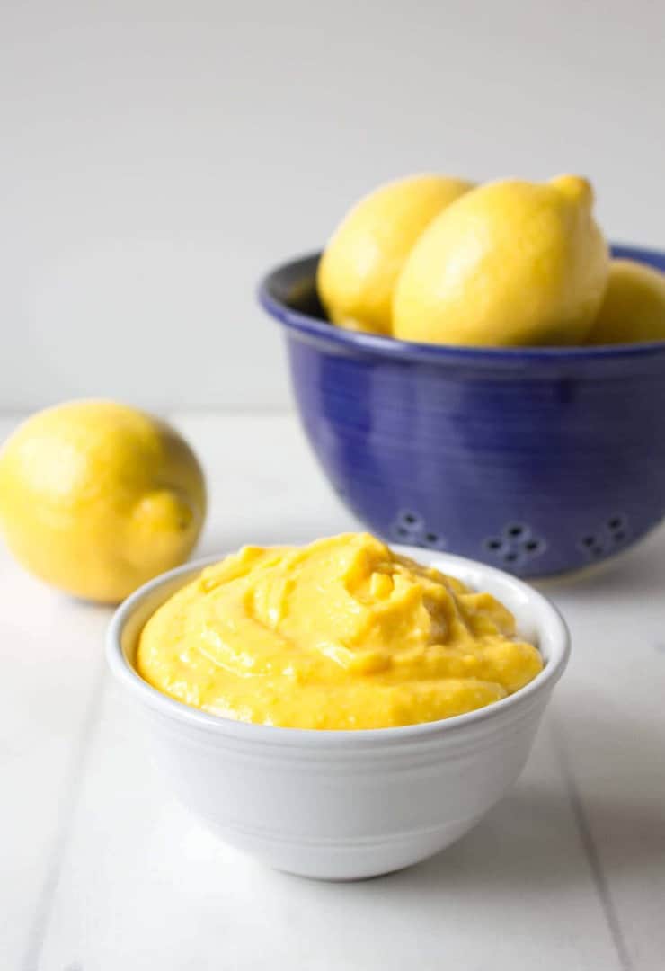 Homemade lemon curd in a small white bowl.