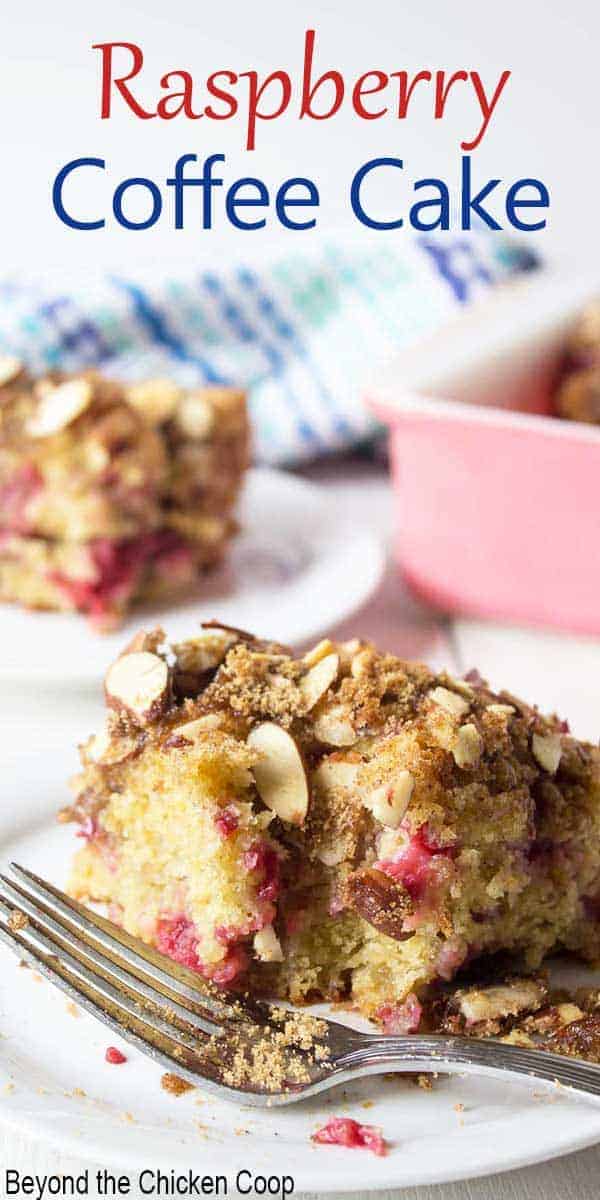 A slice of coffee cake filled with raspberries and topped with almonds.