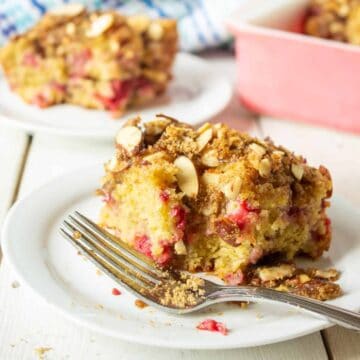 A slice of coffee cake with raspberries.