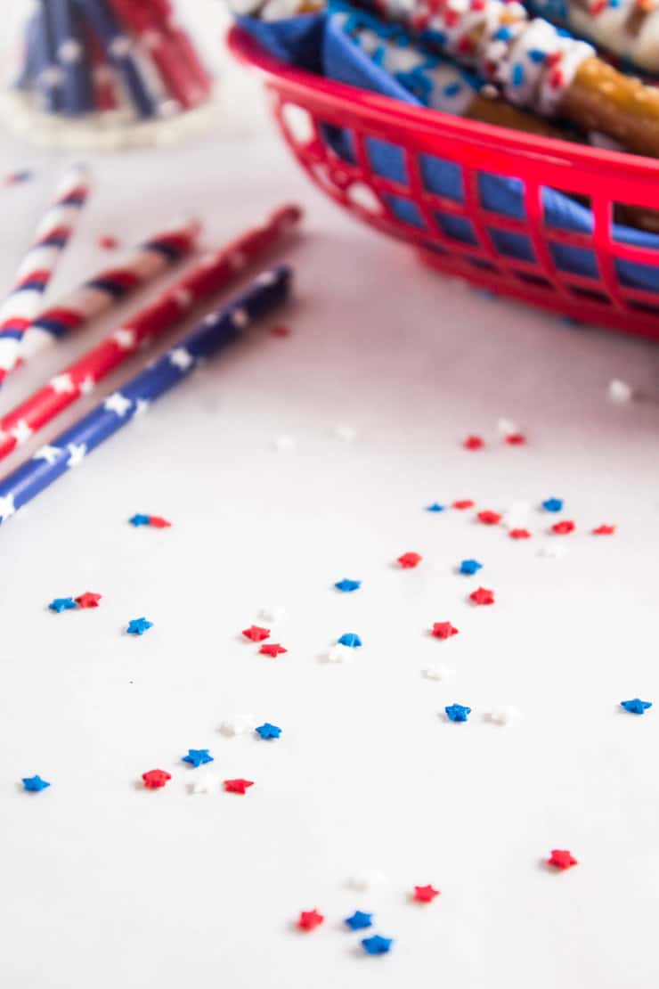 Pretzels covered with white chocolate and sprinkles.