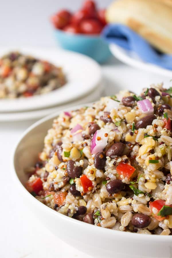 Bowl with quinoa, farro and fresh vegetables. 