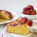A slice of yellow cake topped with fruit.