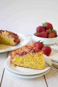 A slice of yellow cake topped with fruit.