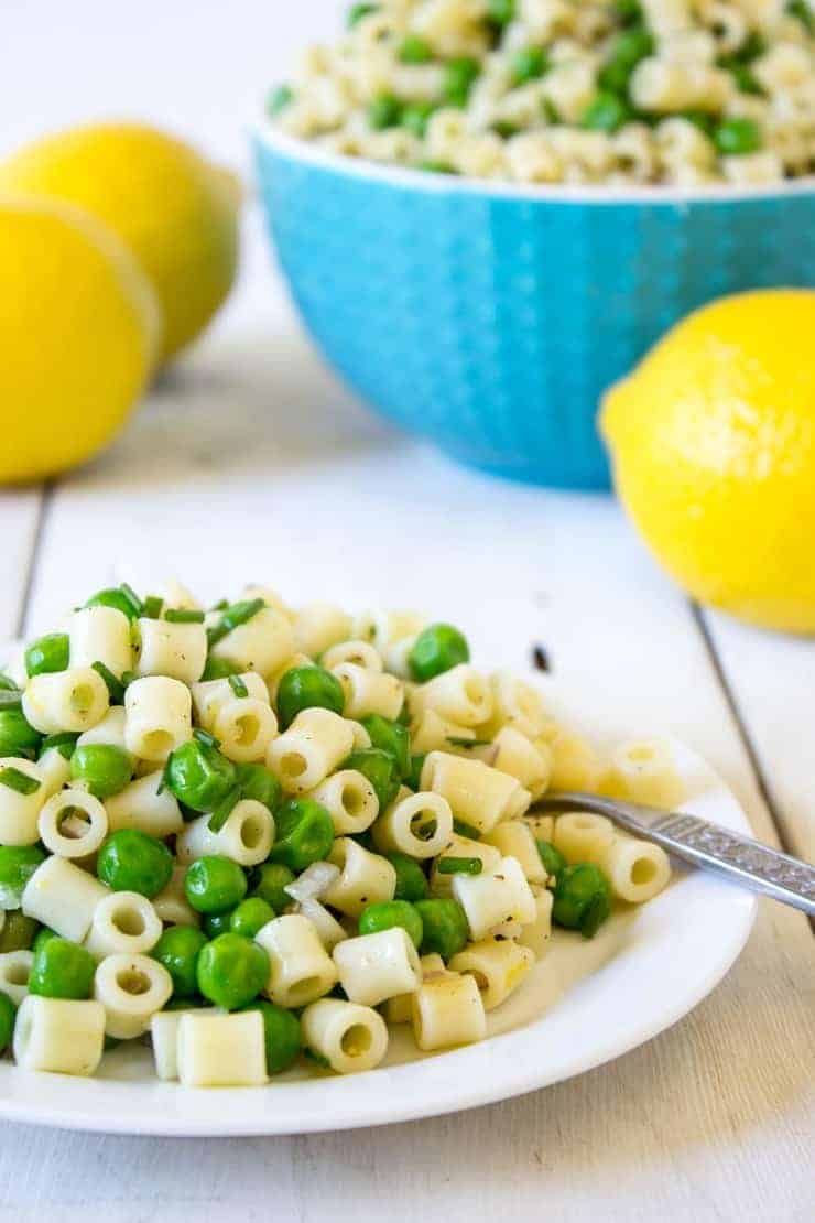 Pasta and Pea Salad with fresh lemon zest on a small plate.