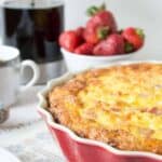 A deep dish pie dish filled with baked egg casserole.