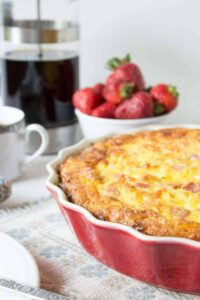 A deep dish pie dish filled with baked egg casserole.