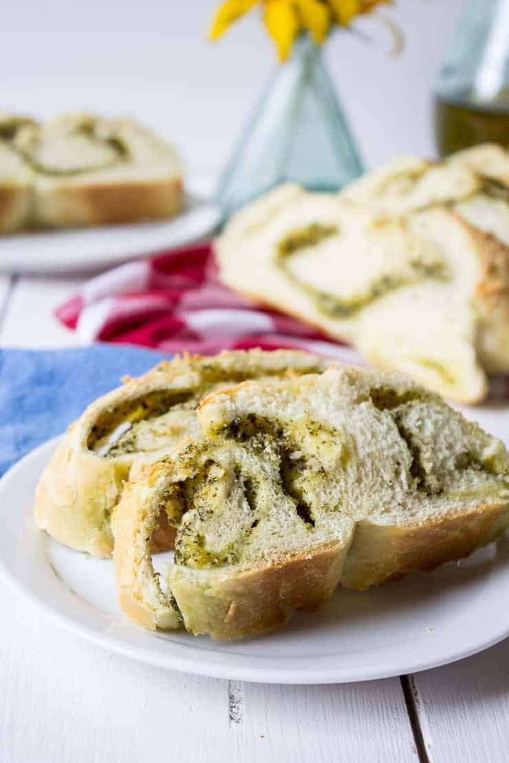 Slices of Cheesy Pesto Bread on a small white plate.