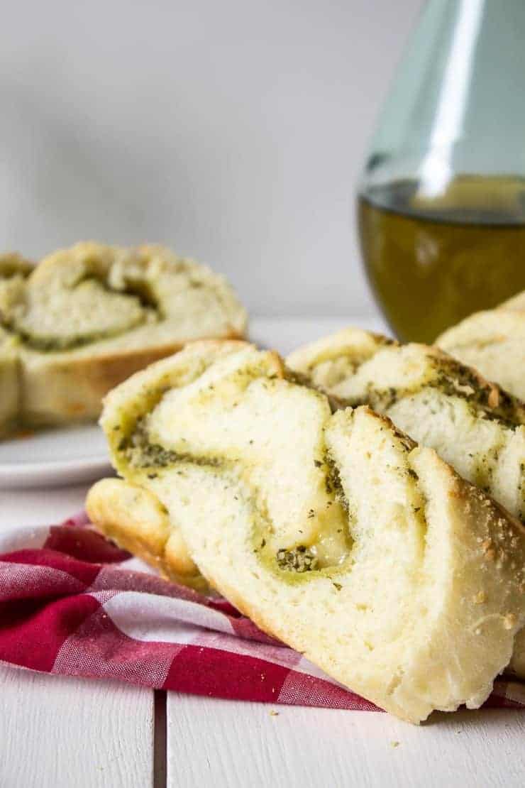 Cheesy Pesto Bread on a red and white checked napkin.