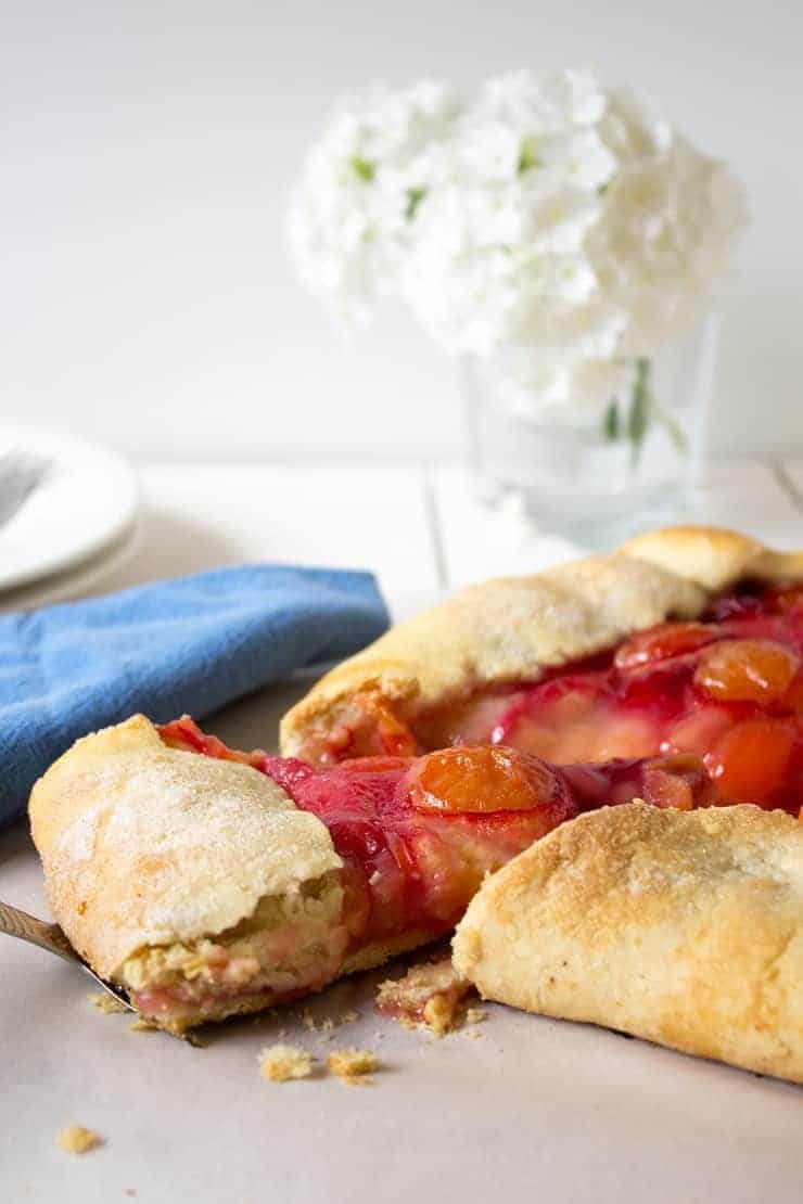 A serving spatula with a slice of plum pie on spatula. 