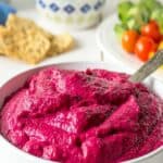 A bowlful of bright pink beet hummus.