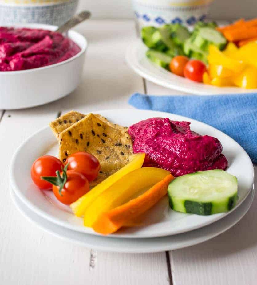 Beet Hummus served with fresh cut veggies and chips.