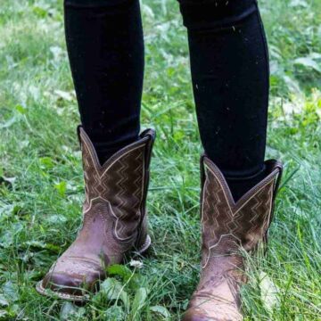 A pair of boots on green grass.