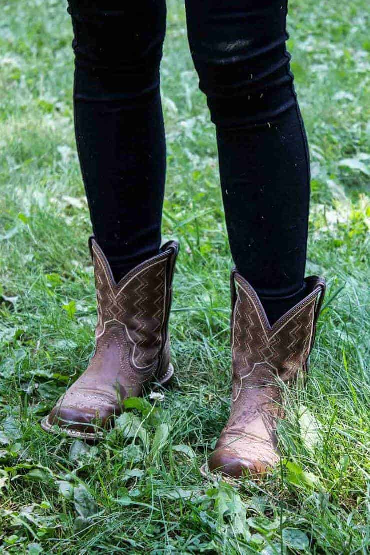 A pair of boots on green grass.