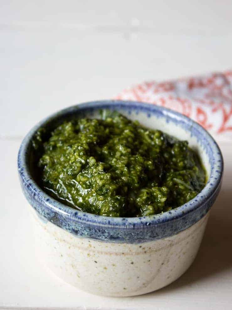 A bowlful of Homemade Basil Pesto in a small serving bowl.
