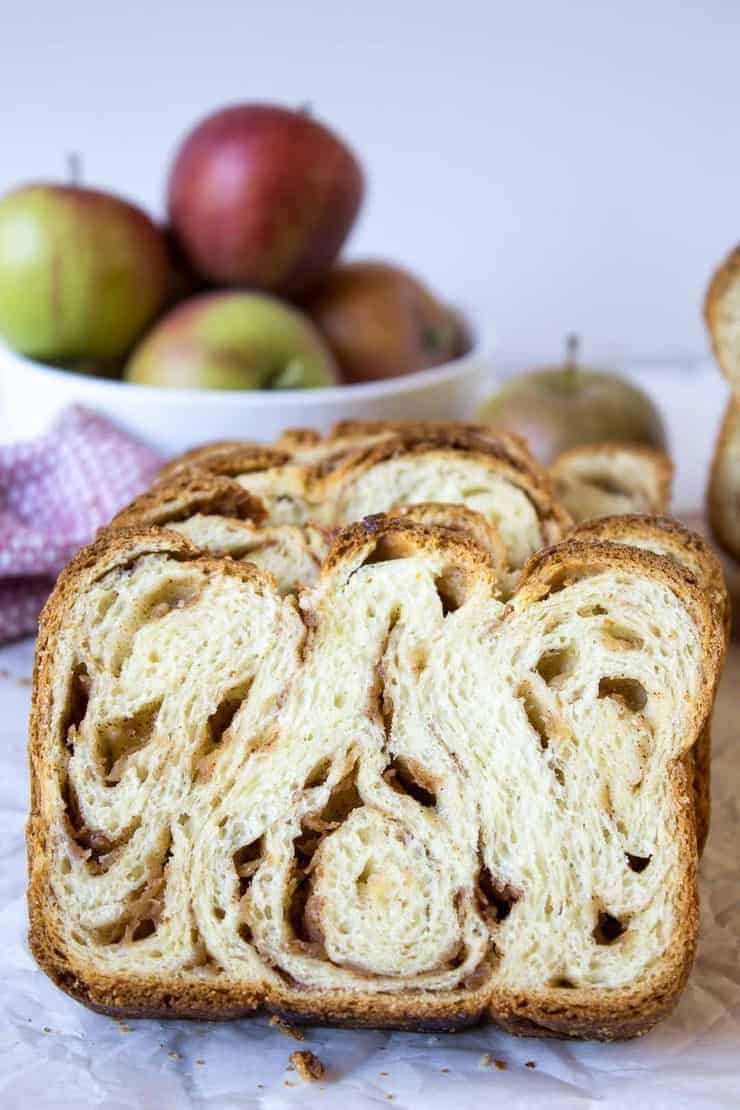 A slice of bread swirled with layers of apples and cinnamon.