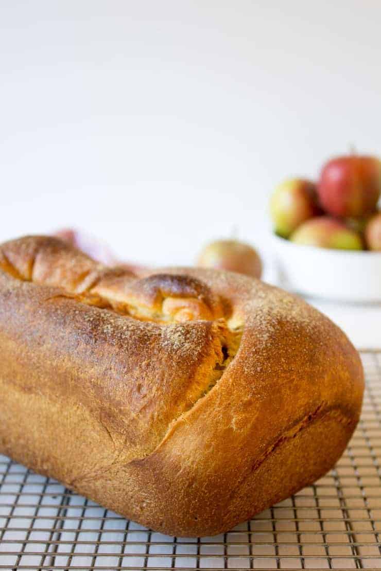 A loaf of bread sitting on a baking rack.