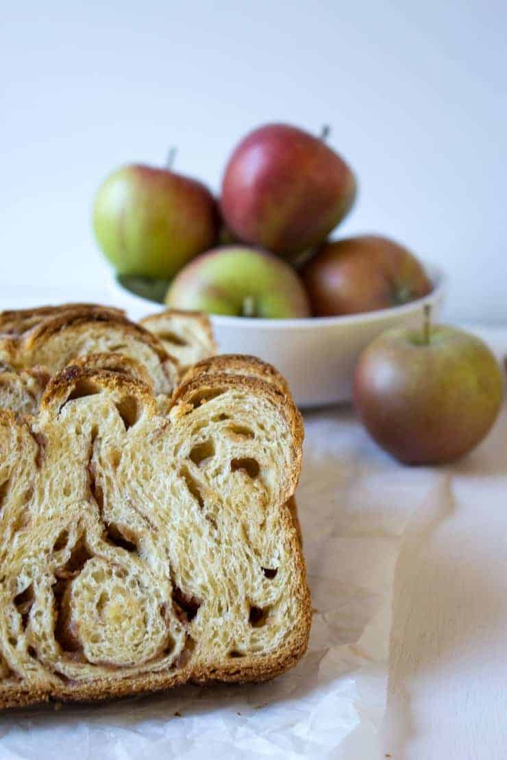 A slice of bread filled with apples and cinnamon.