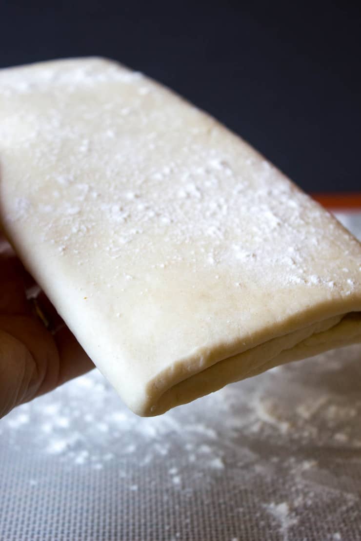 Puff pastry folded into thirds and sprinkled with flour. 