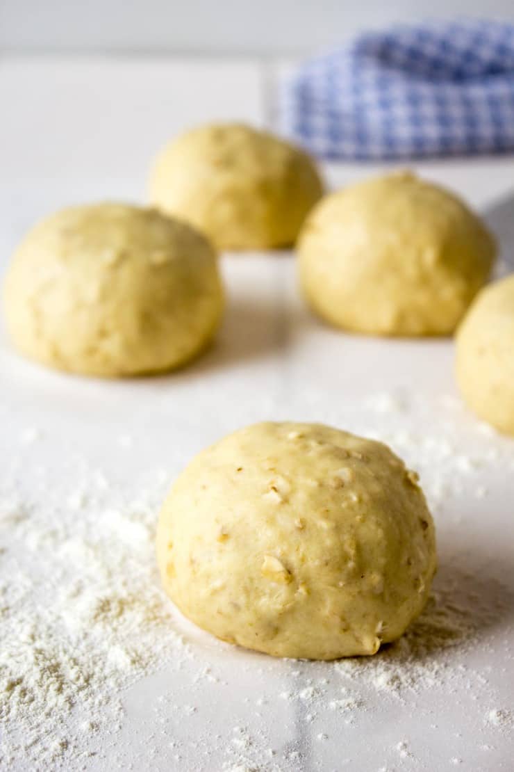 Balls of dough on board with flour. 