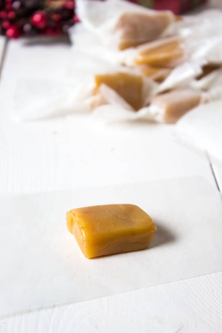 A slice of caramel on a piece of waxed paper. 