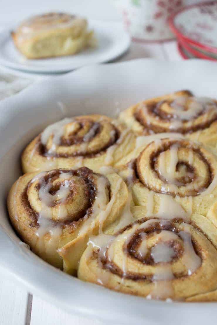 A pan filled with swirled bread topped with a glaze.