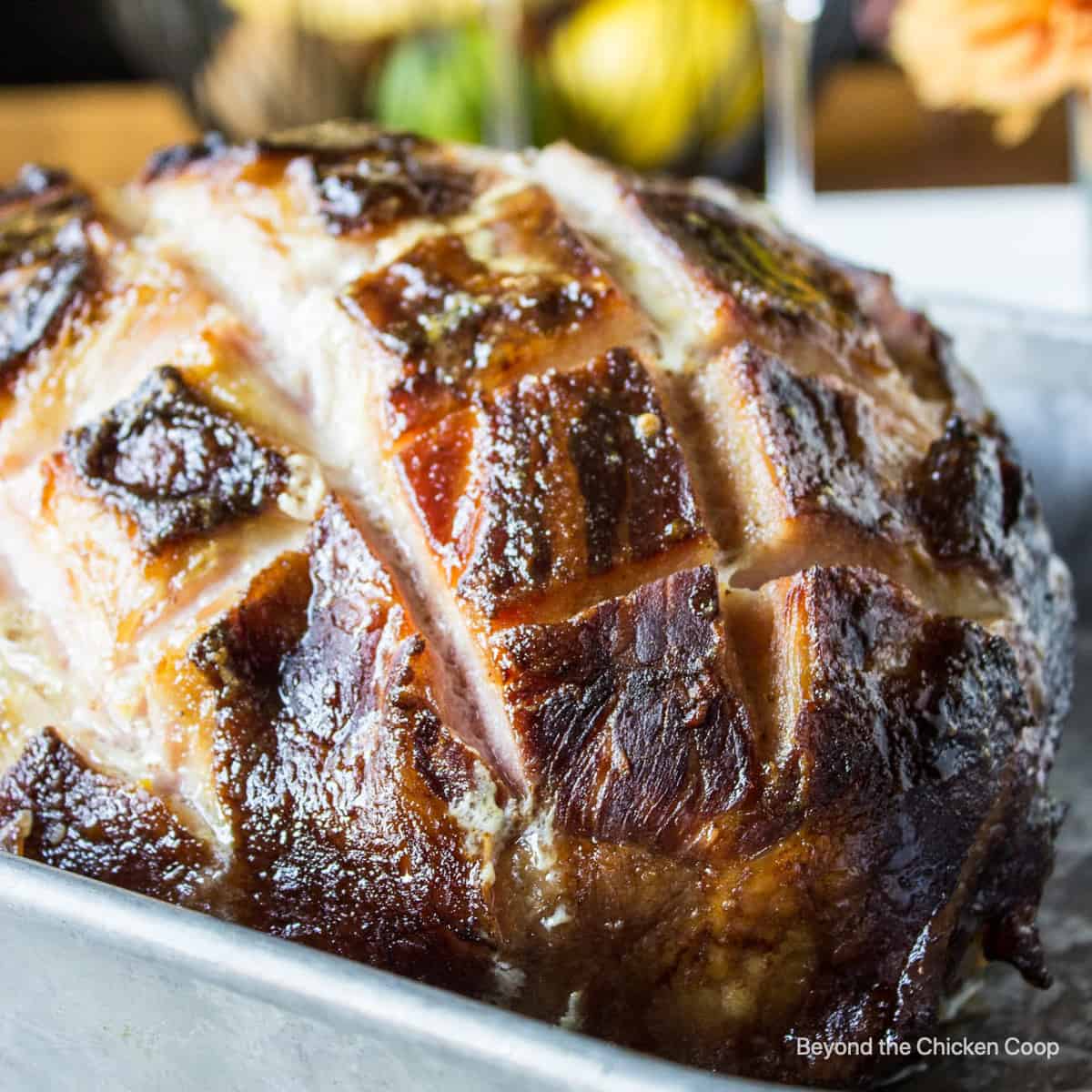 A large baked ham in a baking dish.