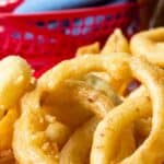 Golden onion rings in a red basket.