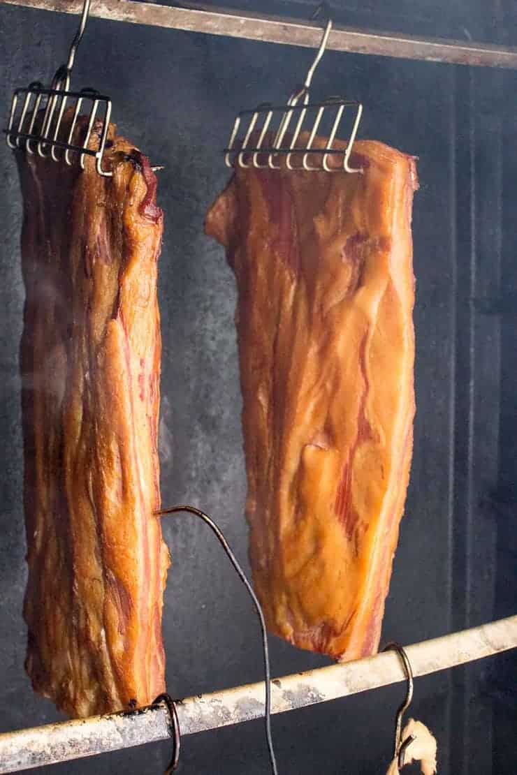 Bacon smoking in a smoker. 