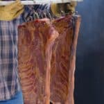 Freshly smoked hams just removed from the smoker.