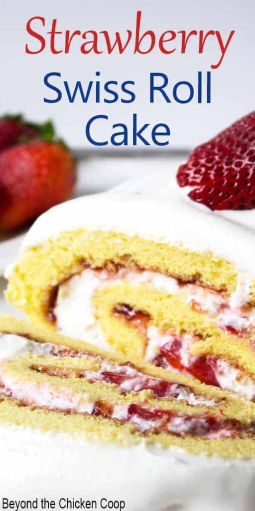 A rolled white cake filled with sliced strawberries and whipped cream.