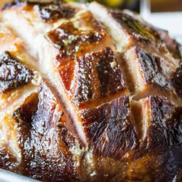 A baked ham with score marks on the top.