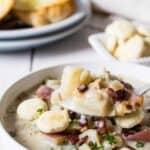 A white bowl filled with new england clam chowder