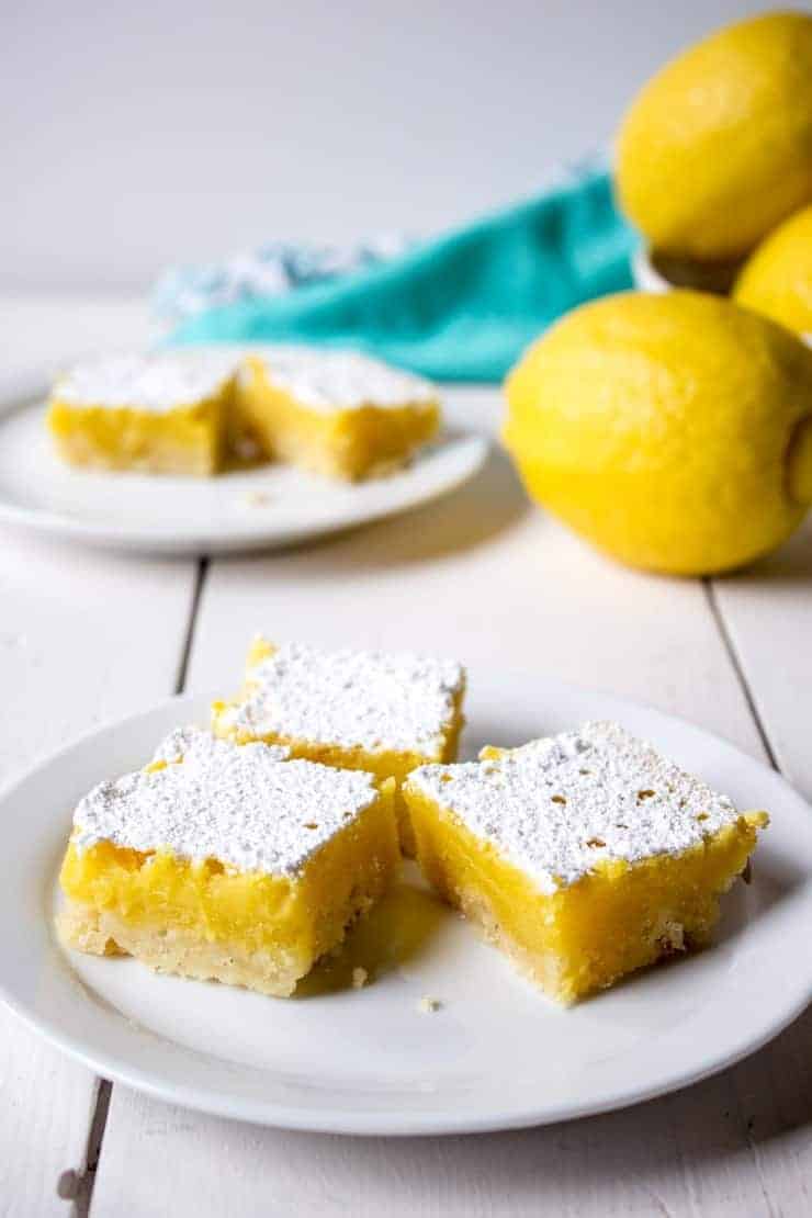 Lemon bars served on a small white plate.