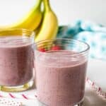 Two glass with a red colored smoothie.