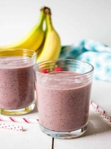 Two glass with a red colored smoothie.